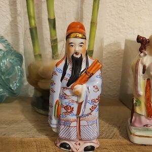 Hand-Painted Ceramic Figurine with Orange and Blue Accents